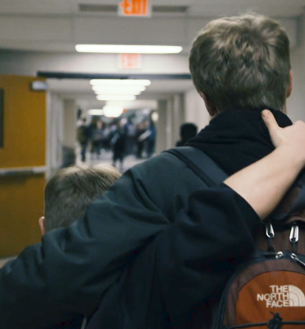 Evan and Jay Hallberg walking down the hallway of Ponaganset High School.