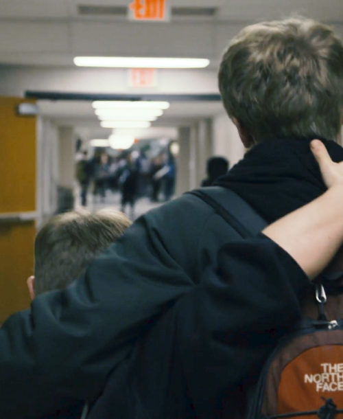 Evan and Jay Hallberg walking down the hallway of Ponaganset High School.