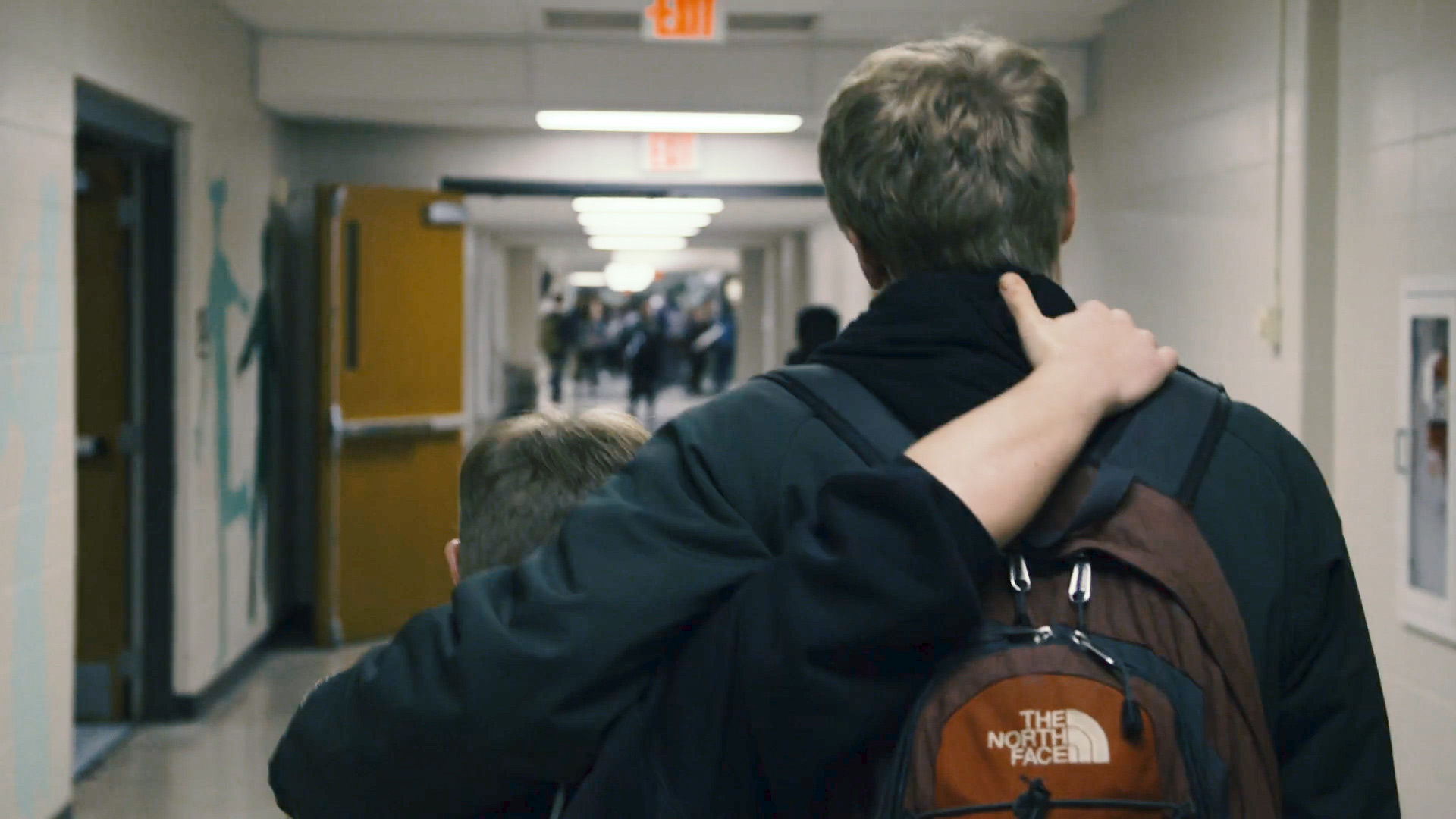 Evan and Jay Hallberg walking down the hallway of Ponaganset High School.