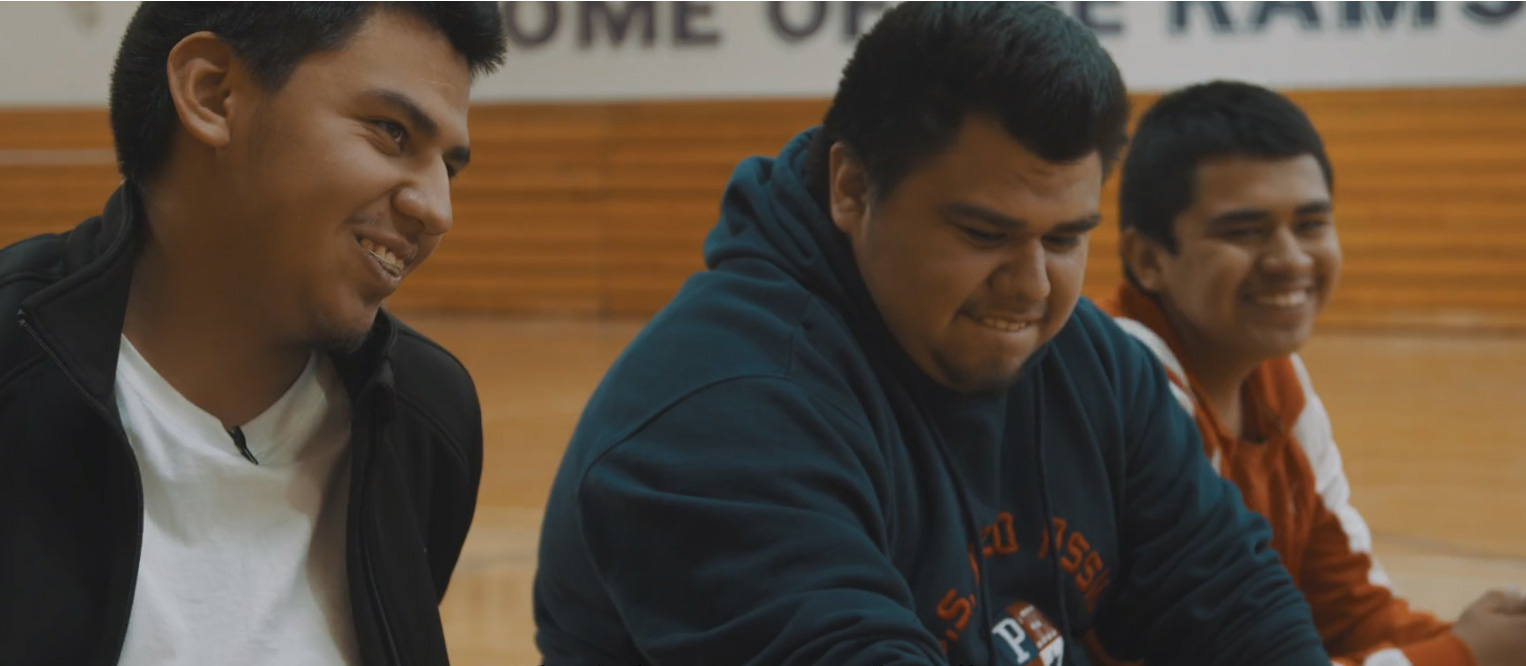 Brothers Isaac, Isaiah and Ivan Garcia are sitting on the Washington High School basketball court looking into the distance.