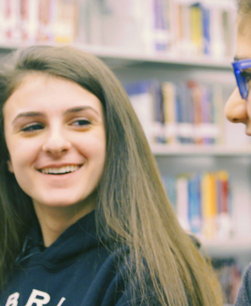 Students from Old Bridge Paige and Bella looking at each other smiling.