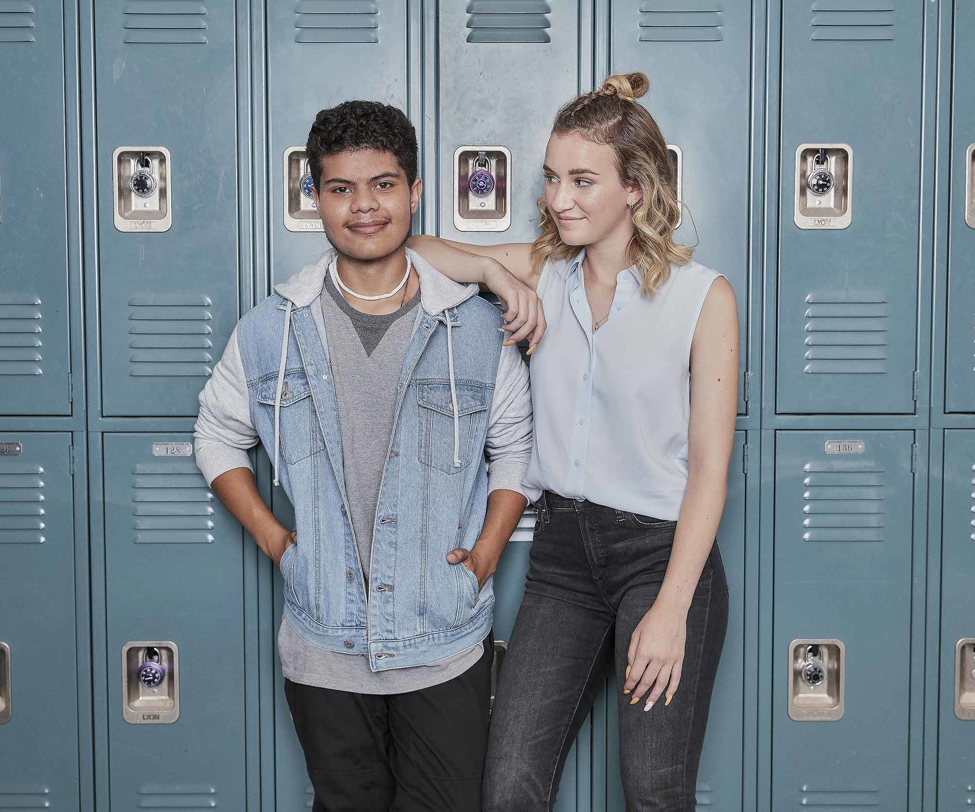 Two students standing in front of lockers.