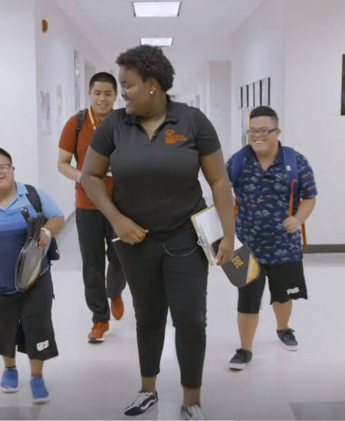 U.S. Youth Ambassador Tajha walks the halls of her high school with fellow students.