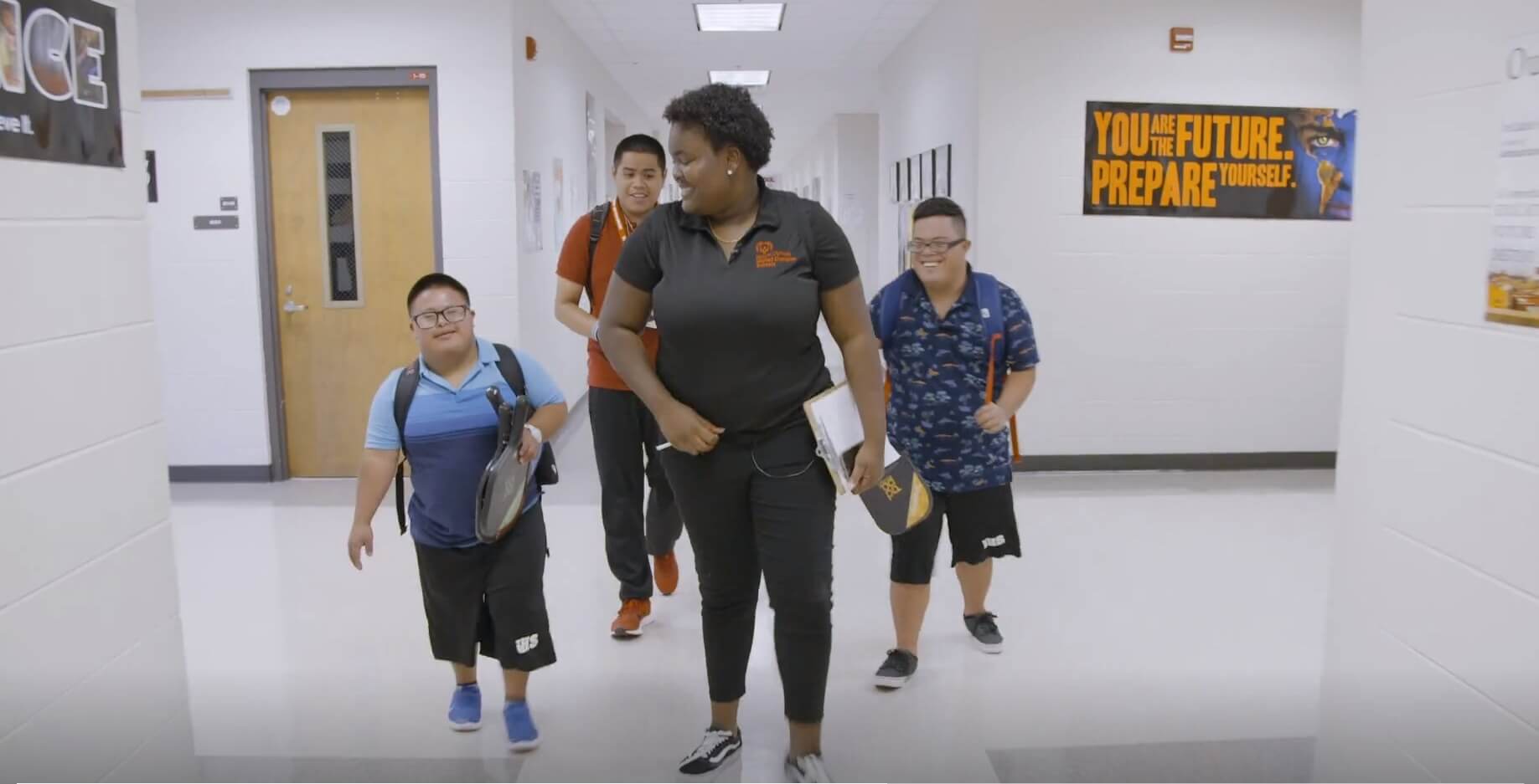 U.S. Youth Ambassador Tajha walks the halls of her high school with fellow students.