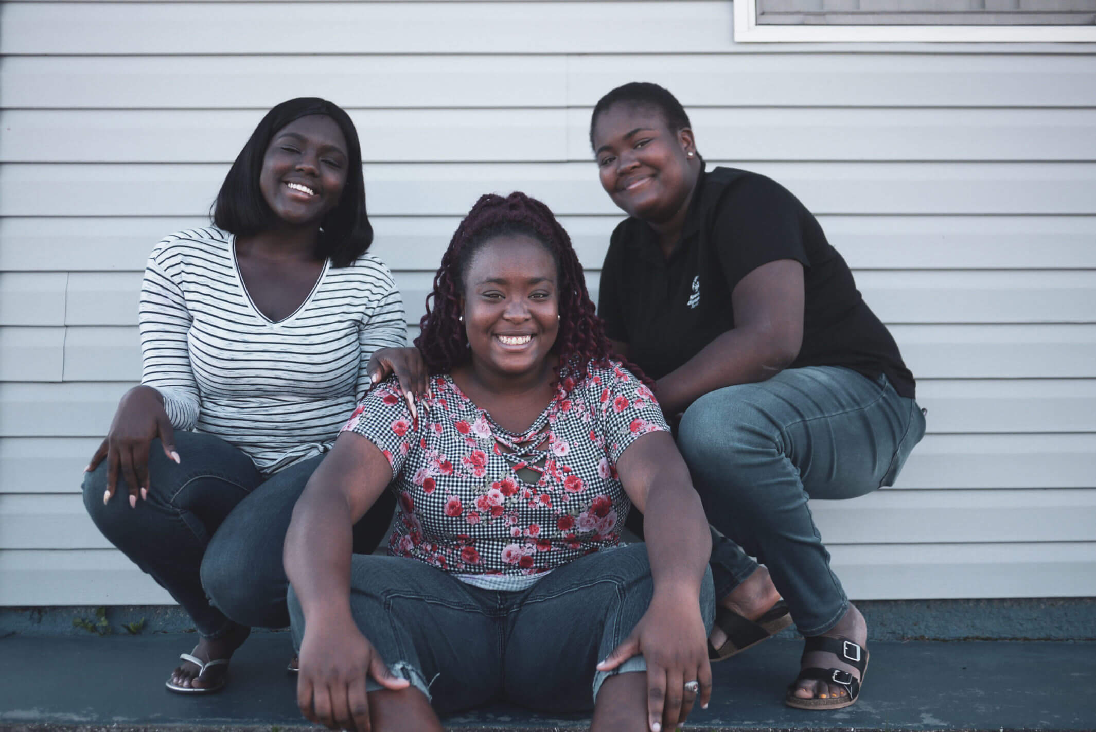 U.S. Youth Ambassador Tajha (right) posing with her two sisters.