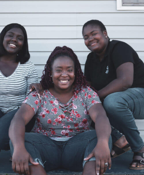 U.S. Youth Ambassador Tajha (right) posing with her two sisters.