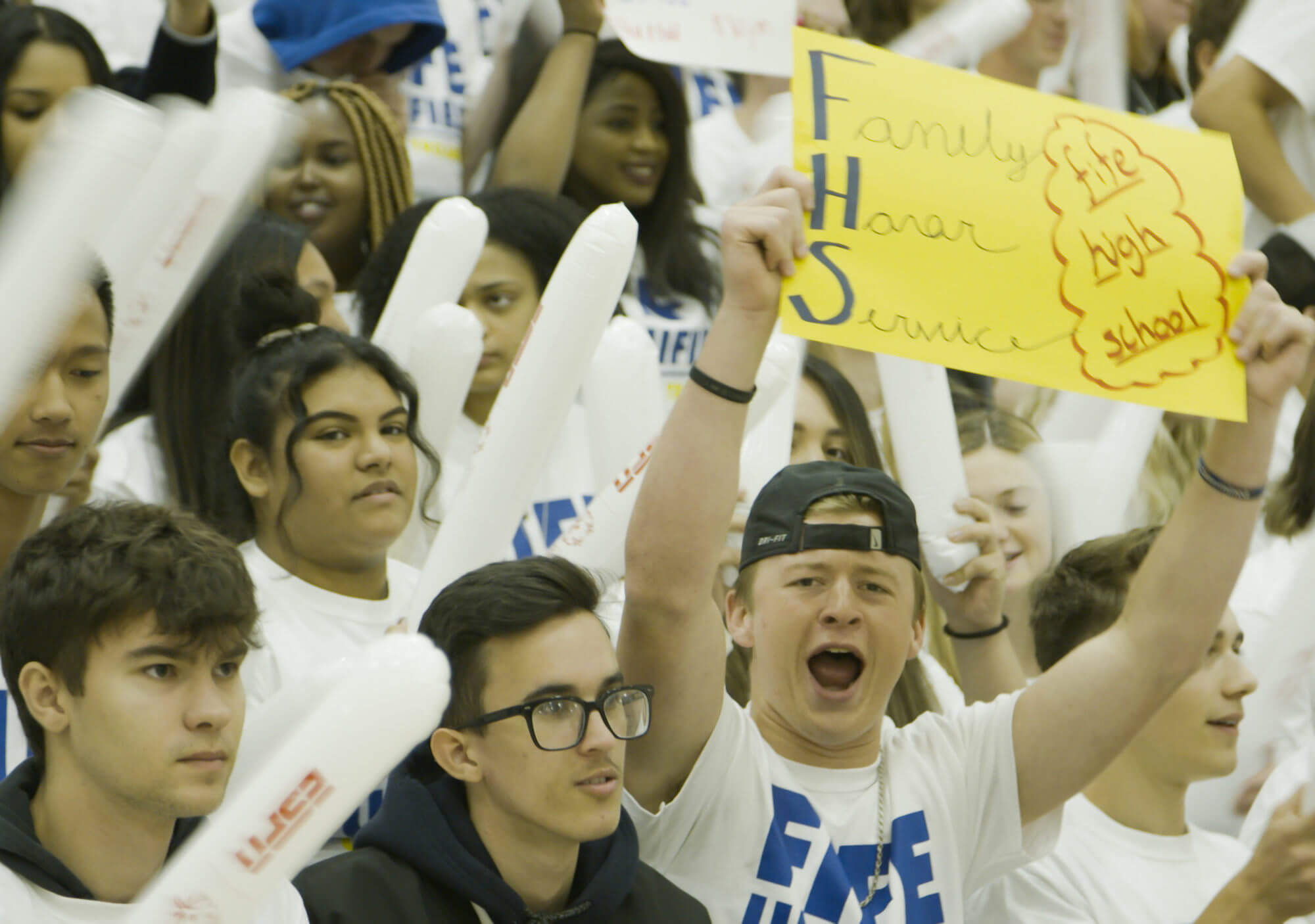 Students in the stands, cheering for a National Banner Presentation.