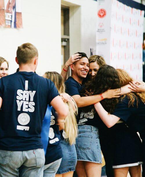 A group of Hendrickson High School students hugging.