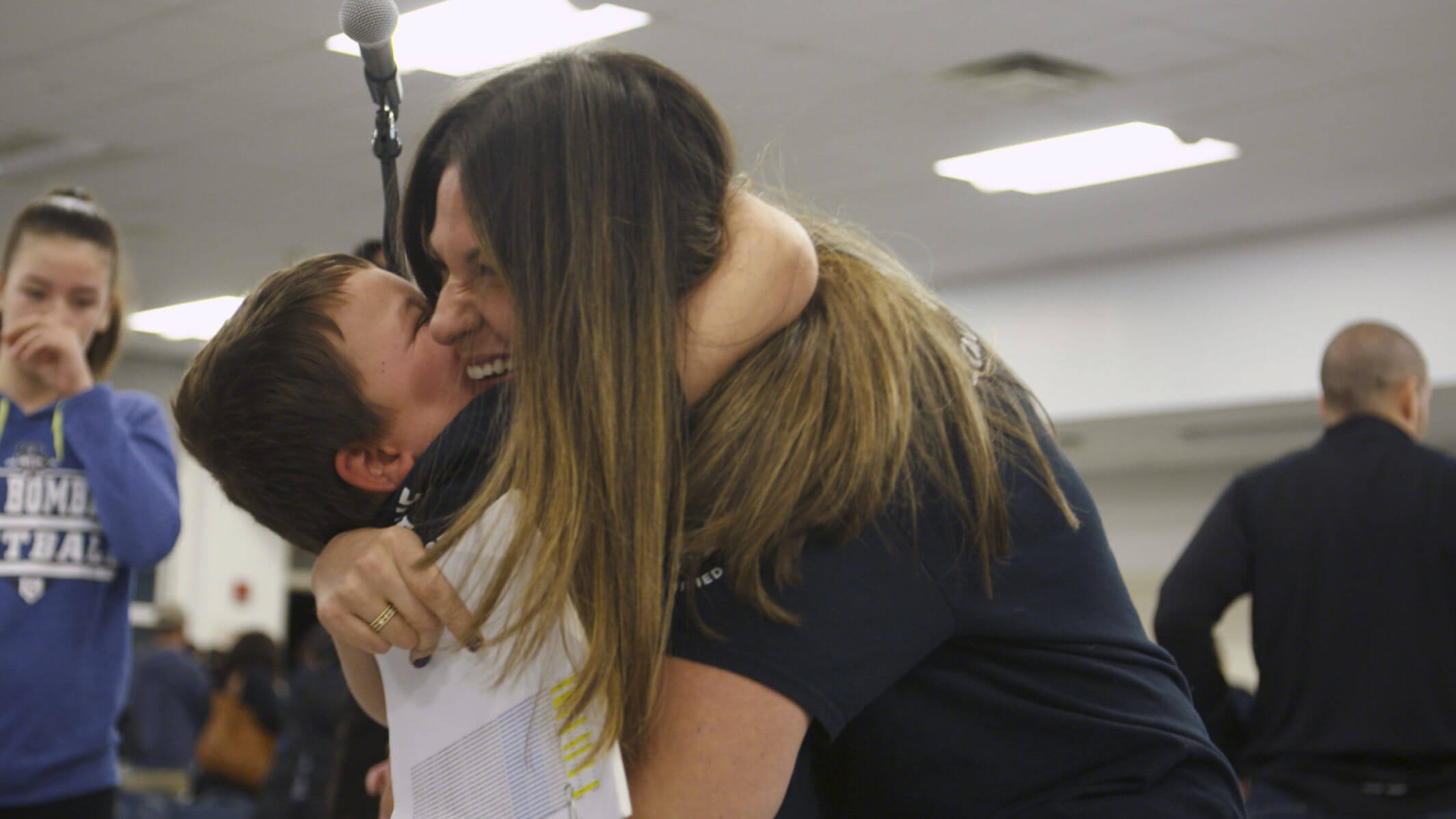 A student hugs a teacher from Sayreville School District in New Jersey.