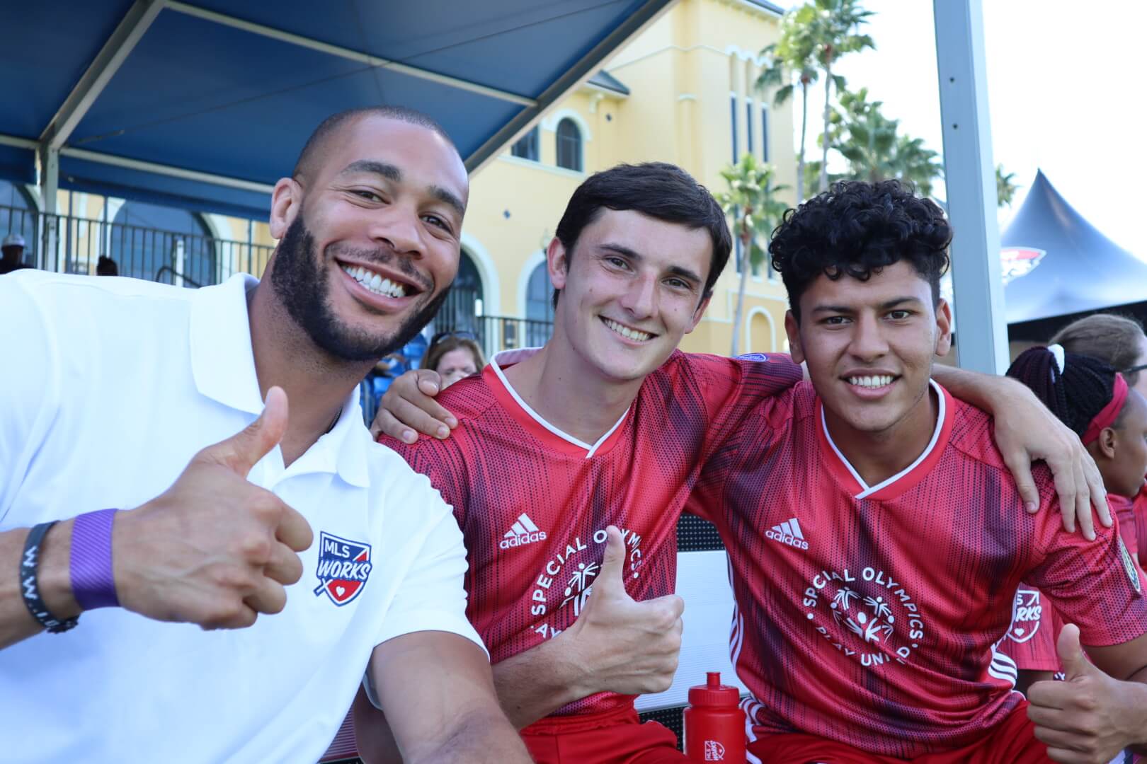 Oguchi Onyewu posing with Unified partners at an MLS all star game.