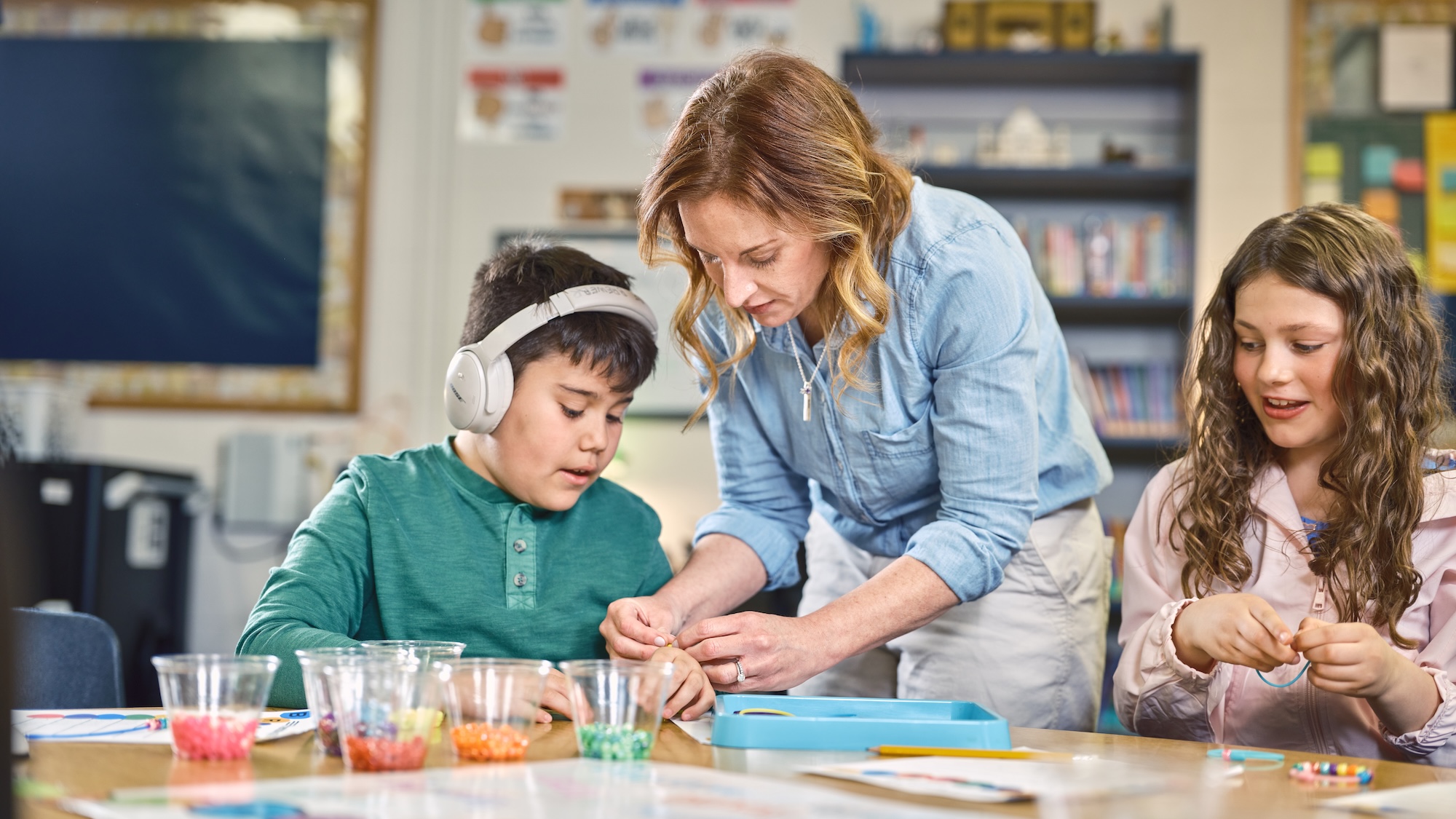 A teacher supports students as they work on a project, fostering collaboration and learning.